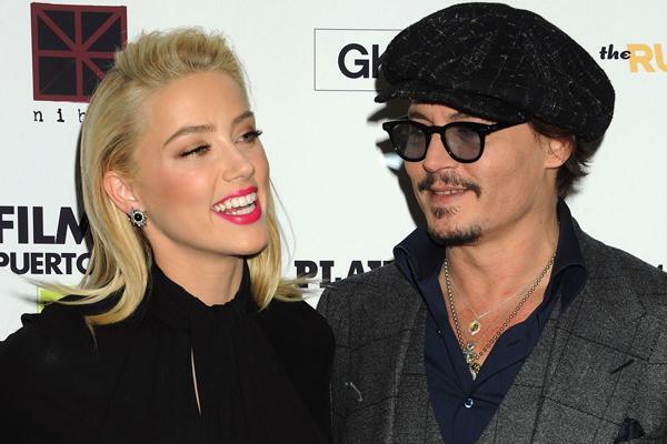 L-R: Amber Heard, Johnny Depp during the The Rum Diary New York Screening, held MOMA in New York City, Tuesday, October 25, 2011..(AP Photo/Jennifer Graylock) Only Italy -- LaPresse --