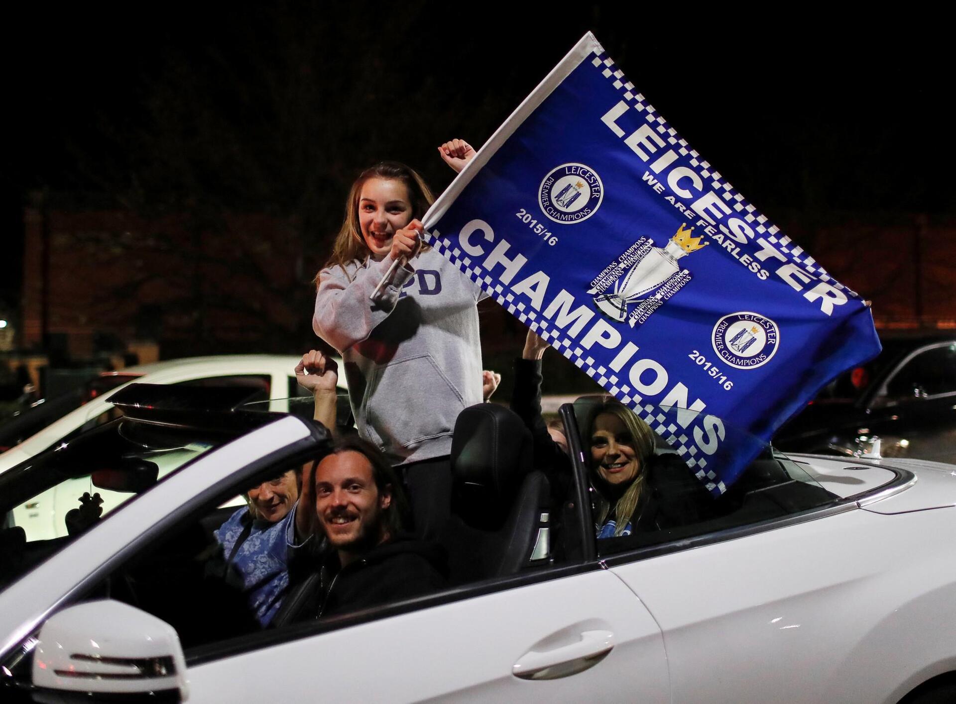 Leicester City fans celebrate outside the King Power stadium after their team won the Premier League title in Leicester, Britain May 3, 2016. REUTERS/Eddie Keogh
