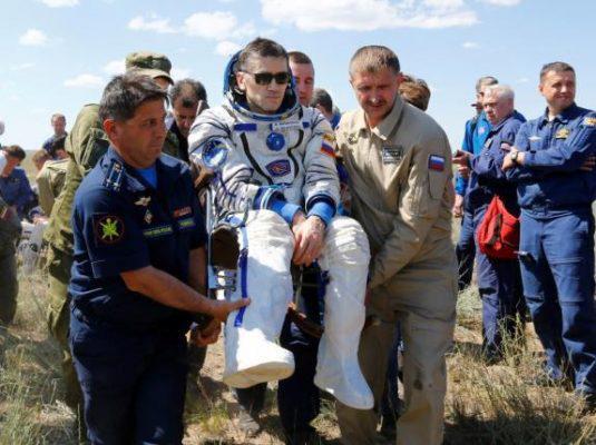 Ground personnel carry International Space Station (ISS) crew member Yuri Malenchenko of Russia shortly after landing near the town of Dzhezkazgan (Zhezkazgan), Kazakhstan, June 18, 2016. REUTERS/Shamil Zhumatov