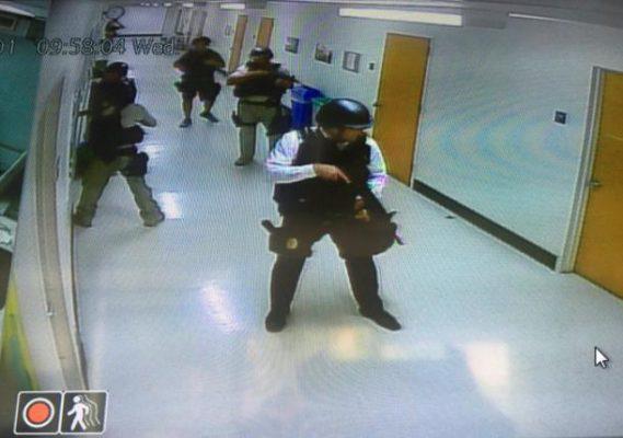 Police officers search corridors and rooms after the report of an active shooter on a UCLA campus in Los Angeles, California, U.S. June 1, 2016 in a still image from a CCTV camera. Kara Leung/UCLA/Handout via REUTERS