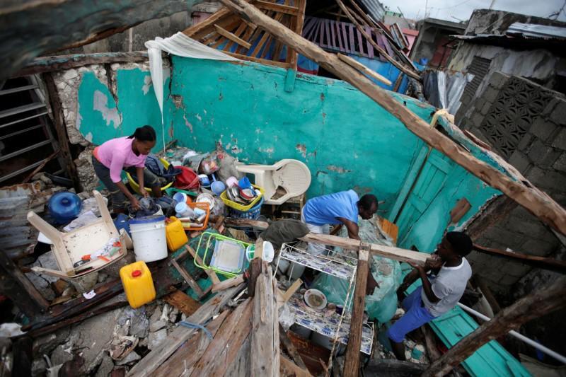 Residents work clearing a house destroyed by Hurricane Matthew in Les Cayes, Haiti. REUTERS/Andres Martinez Casares