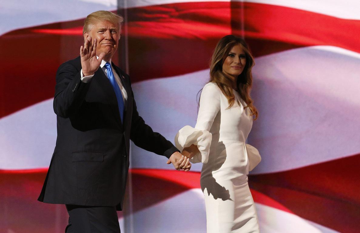 epa05431374 Donald Trump (L) escorts his wife Melania (R) after her speech during the second session on the first day of the 2016 Republican National Convention at Quicken Loans Arena in Cleveland, Ohio, USA, 18 July 2016. The four-day convention is expected to end with Donald Trump formally accepting the nomination of the Republican Party as their presidential candidate in the 2016 election. EPA/MICHAEL REYNOLDS