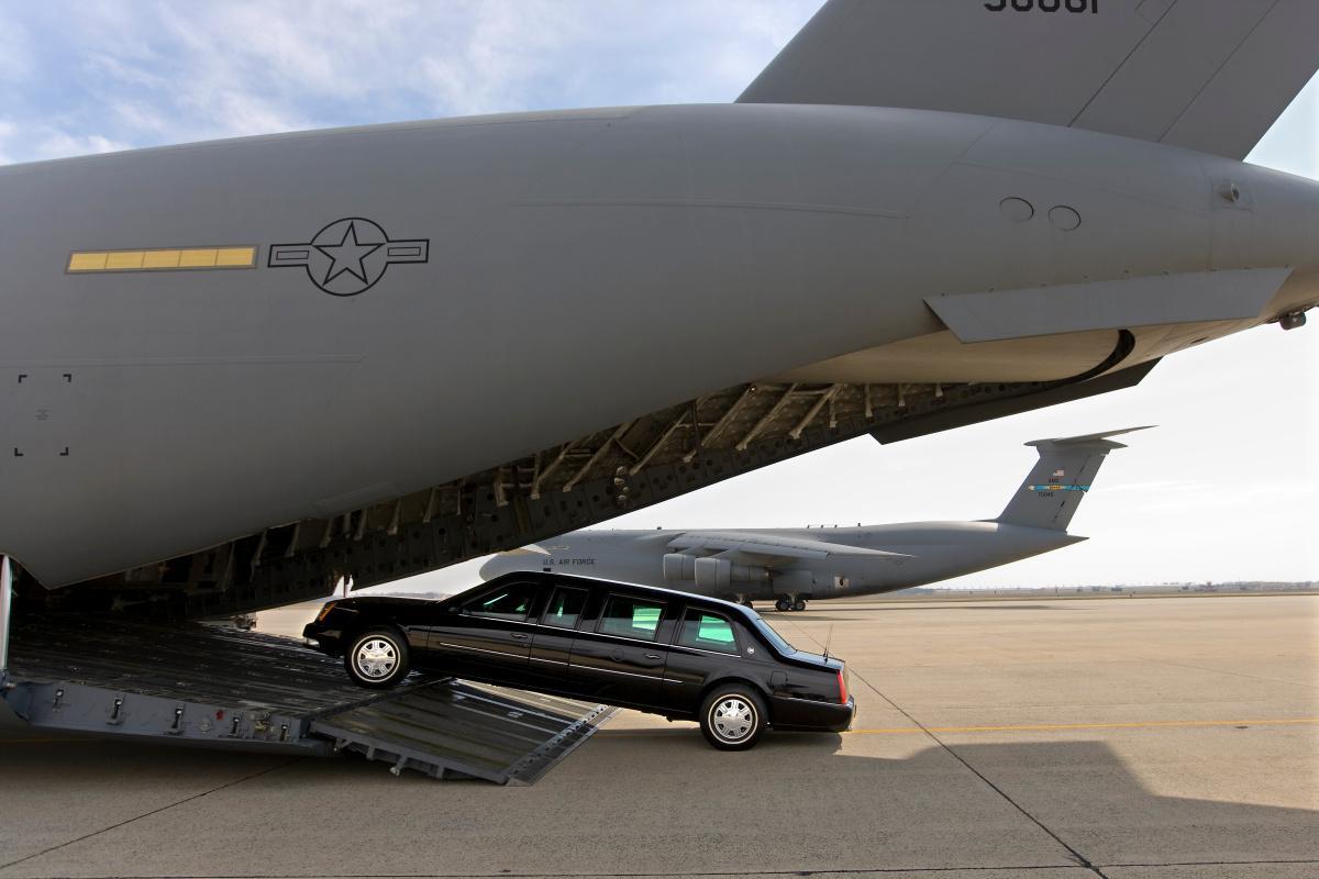 28 Mar 2008, Maryland, USA --- A Presidential limousine is loaded onto a C5 military transport plane bound for eastern Europe, where President Bush is headed next week. A "secure package" of motorcade vehicles, including the limousines and a fleet of Secret Service SUVs is transported to the site of every presidential visit. --- Image by © Brooks Kraft/Corbis